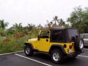 Shiny Yellow Rental Jeep with Scenery